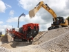 Sandvik crusher and CAT excavator working in the recycling demo area at Hillhead